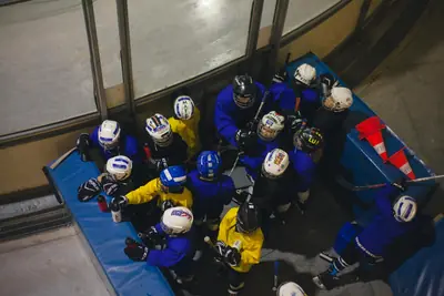 Youth hockey team huddled on the bench